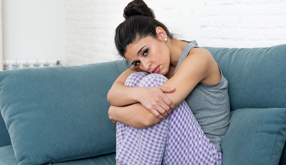 A woman sitting on a sofa during perimenopause
