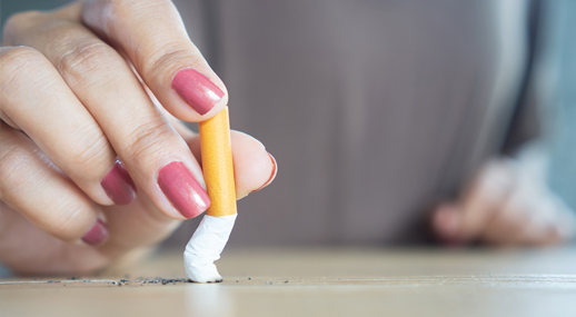 A woman stubbing out a cigarette